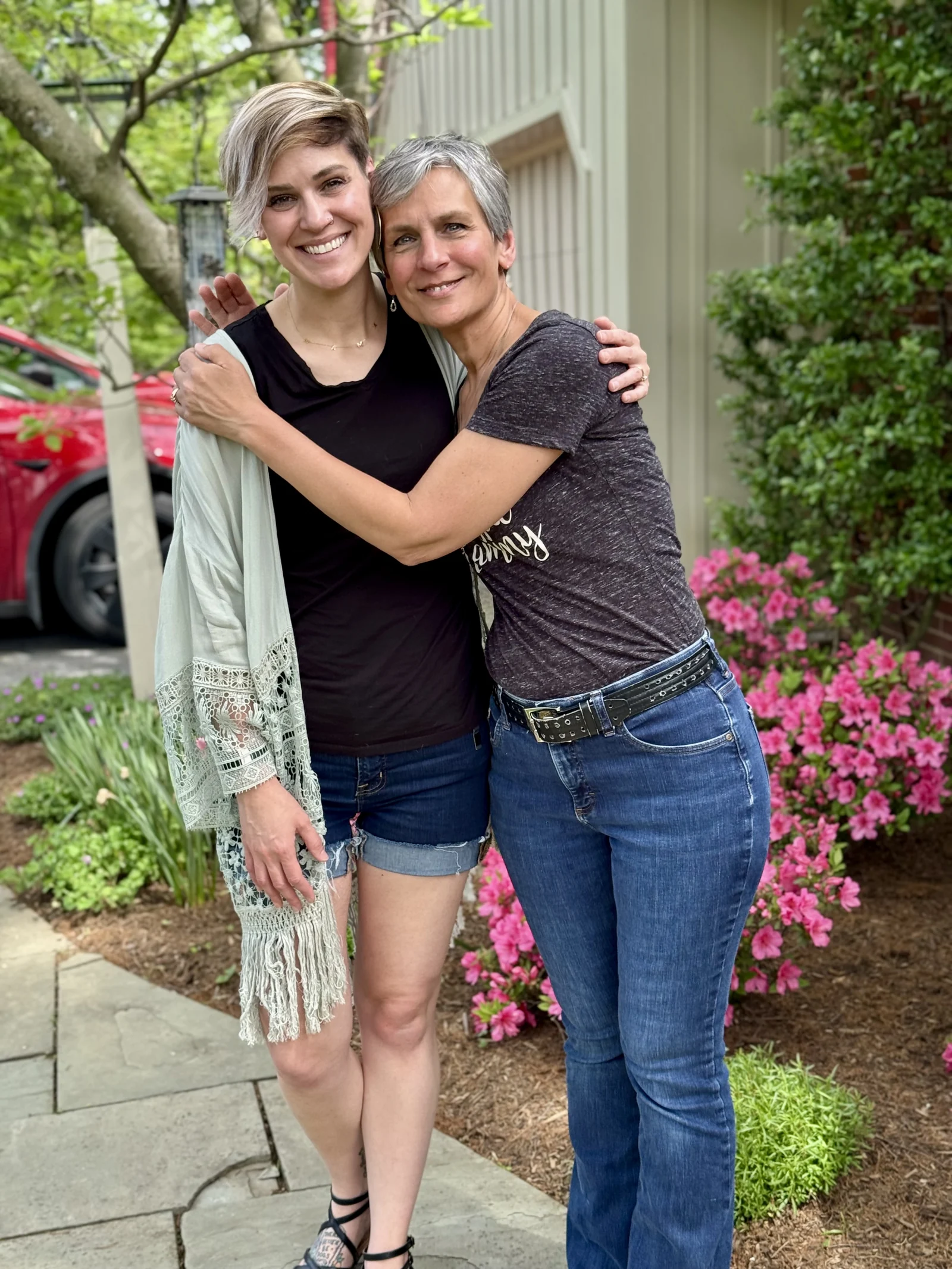 Vanessa and Pam smiling and embracing outdoors